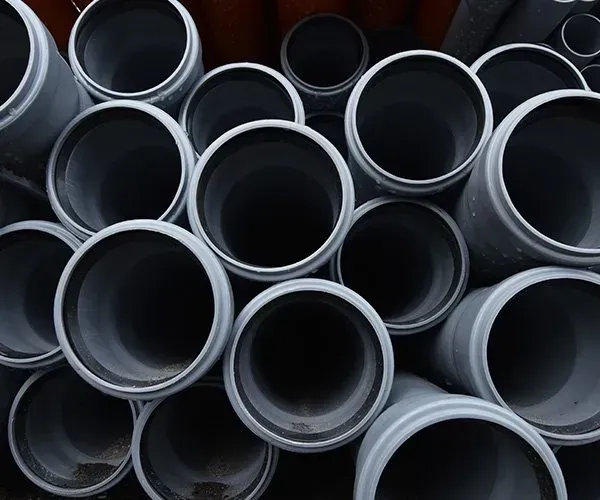 Grey Plastic Pipes Stacked Together — SDA Plumbing in Alice Springs, NT