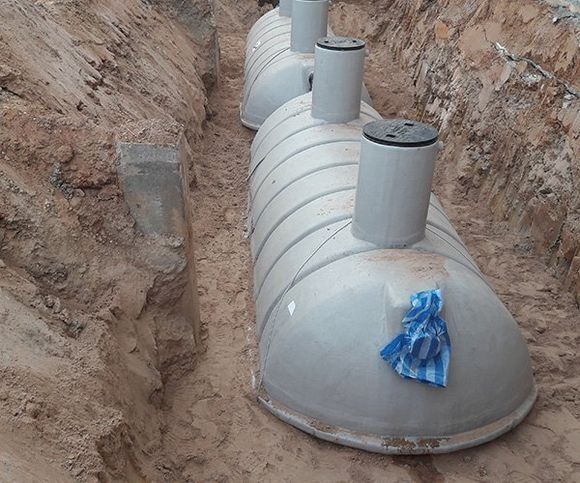 Three Grey Septic Tanks Installed in A Dirt Trench — SDA Plumbing in Alice Springs, NT
