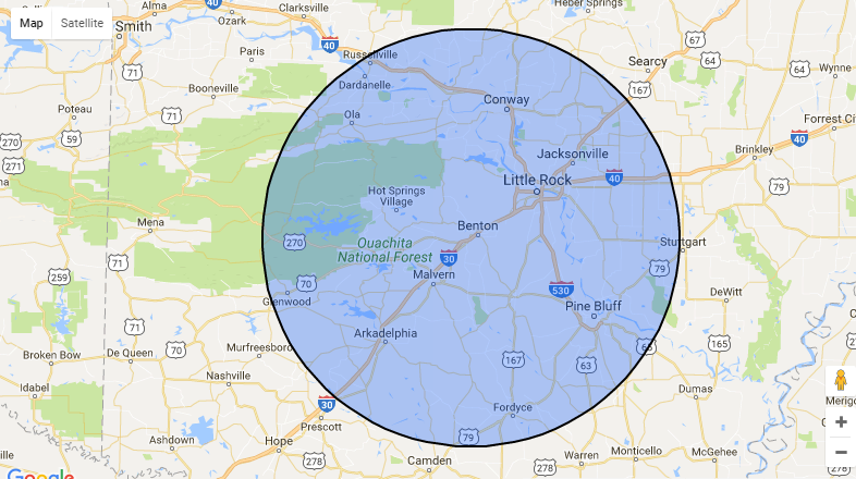 Map with a large translucent blue circle centered over a town area, showing a coverage or radius zone.