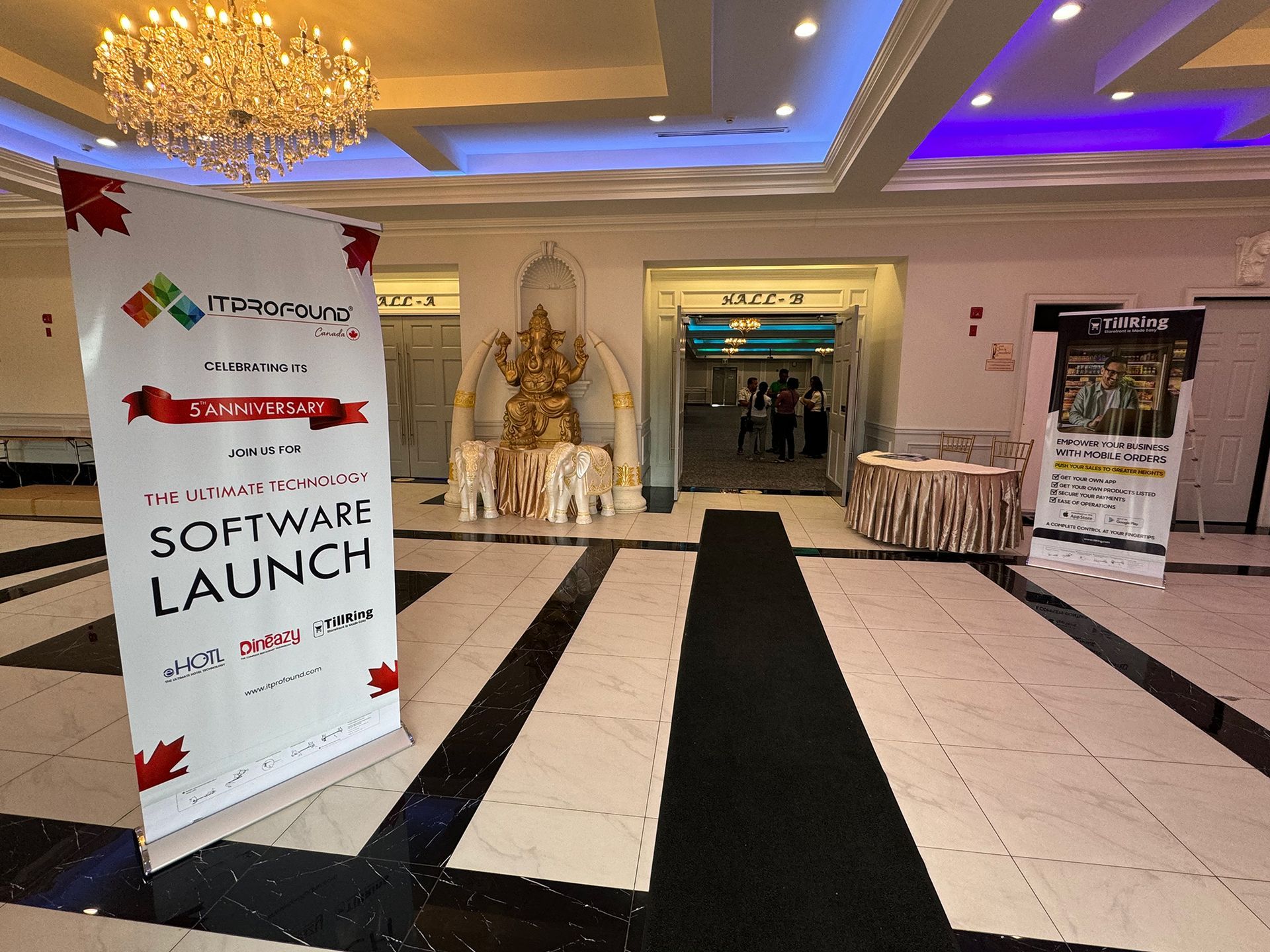 Hotel lobby entrance with a “Software Launch” sign and event banners on either side of a decorated doorway