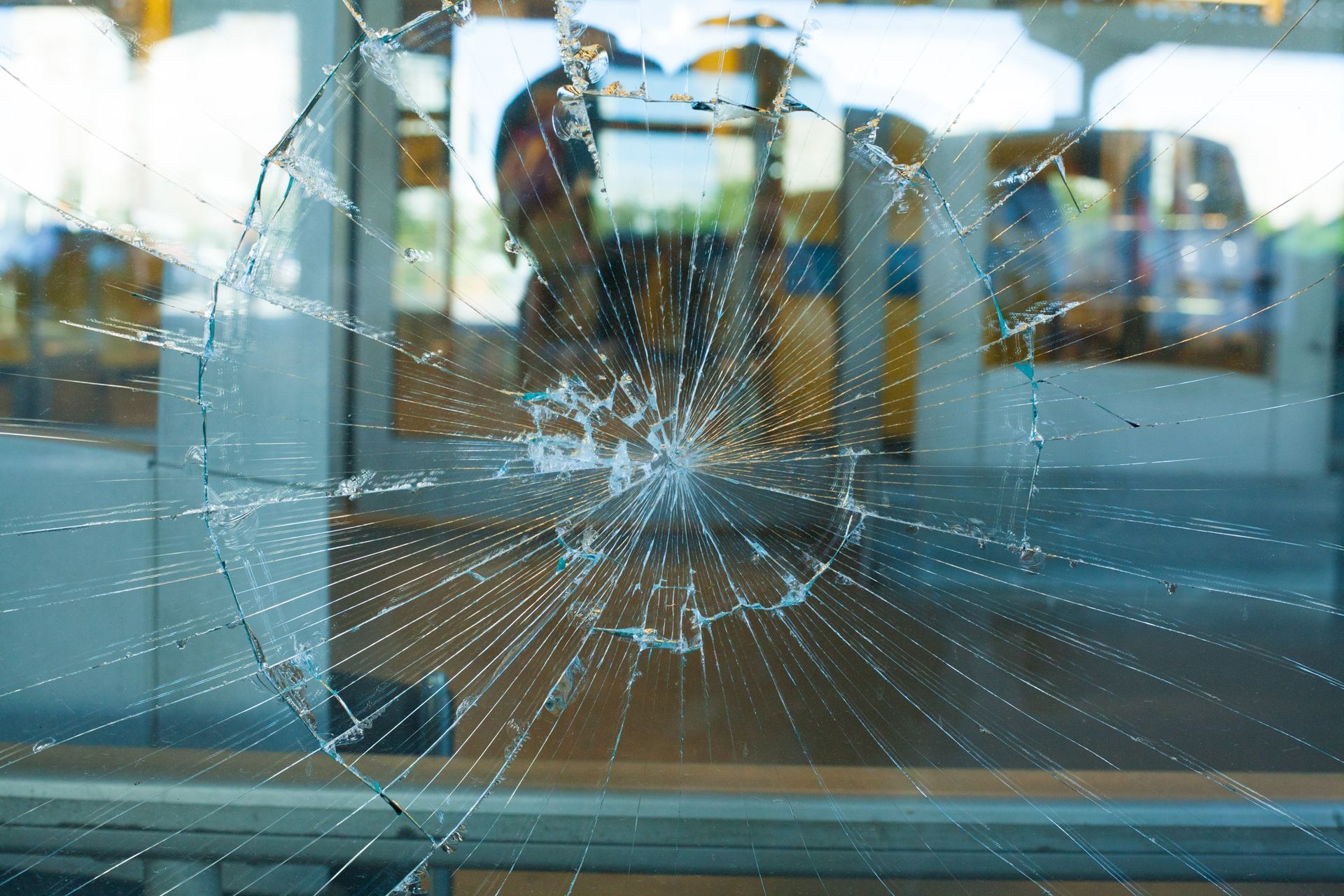 Shattered storefront glass pane Shattered storefront glass pane