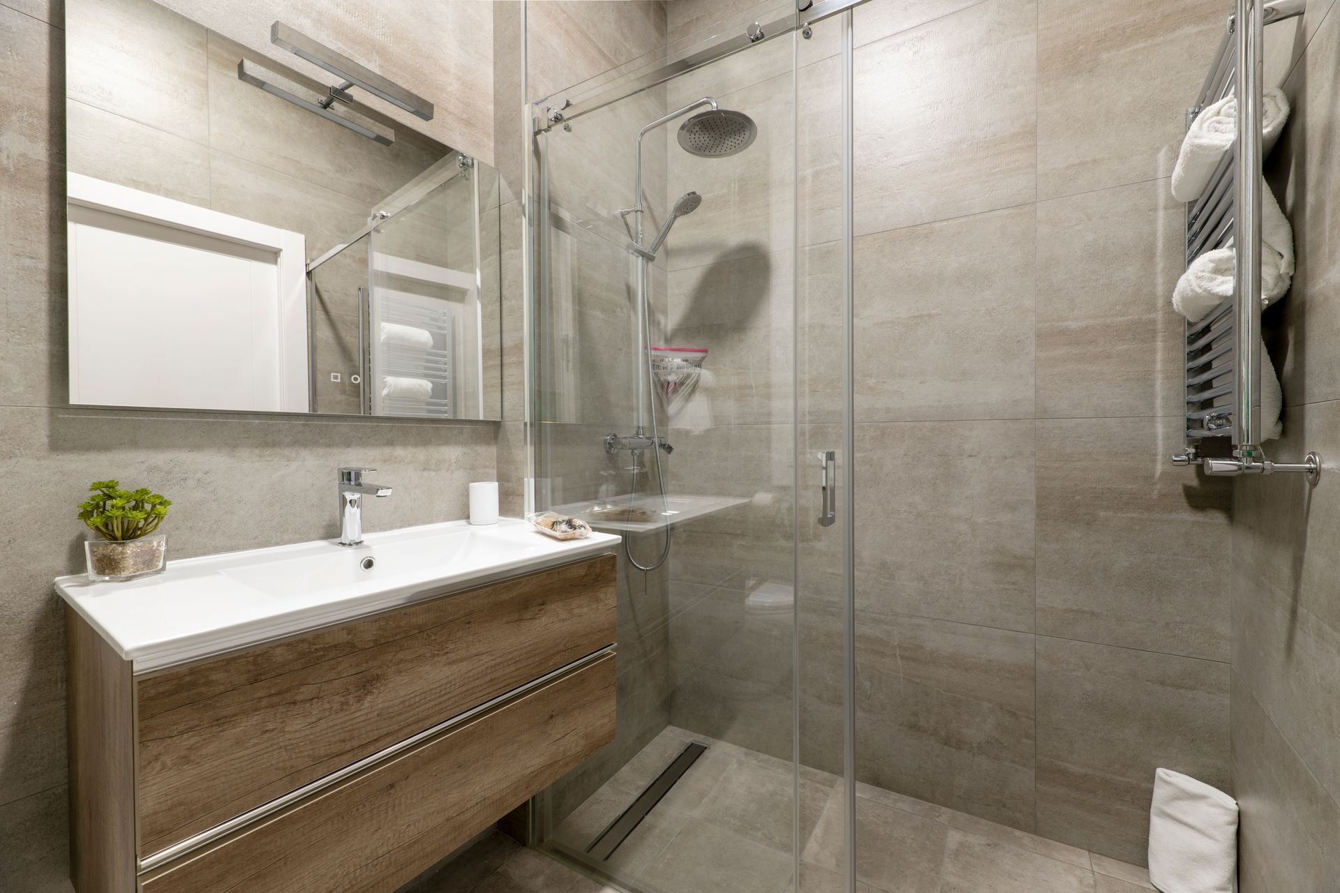 Modern bathroom featuring custom sliding glass shower doors. Modern bathroom featuring custom sliding glass shower doors.