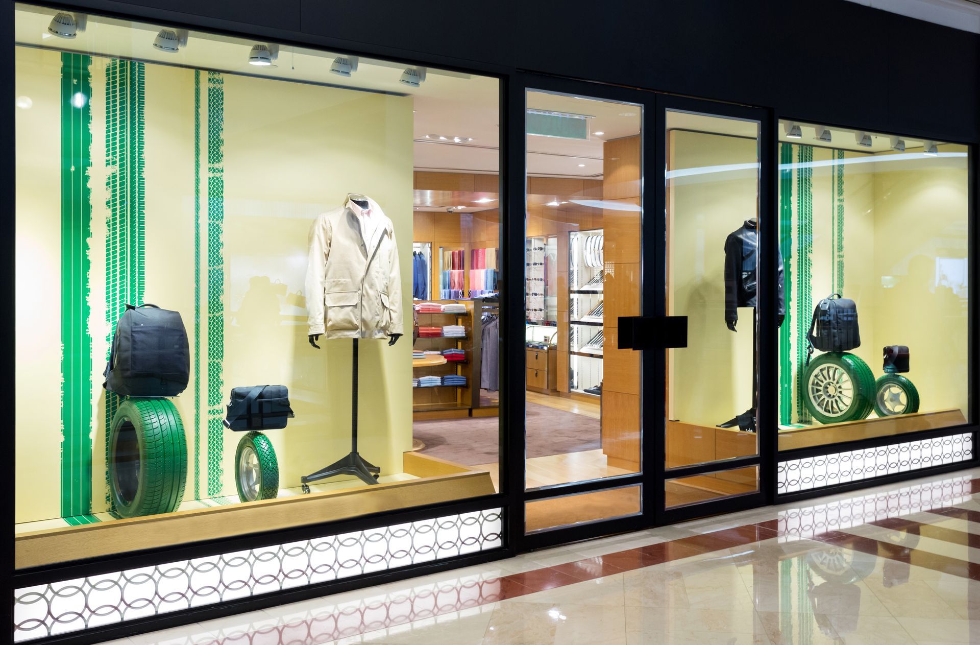 Commercial glass storefront with lit retail display window.