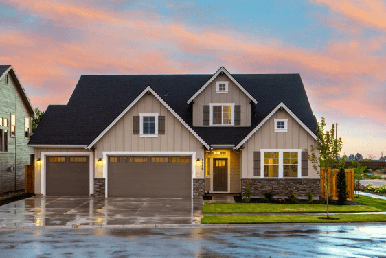 large exterior painted home lit up at dusk