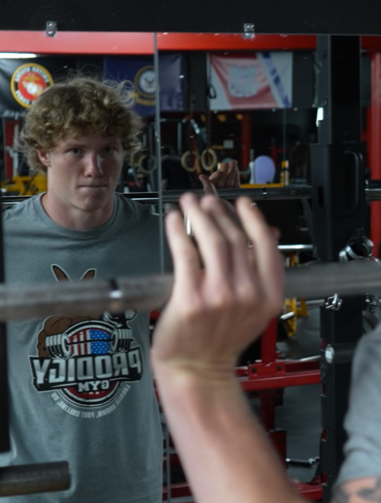 A man and a woman are posing for a picture in a gym.