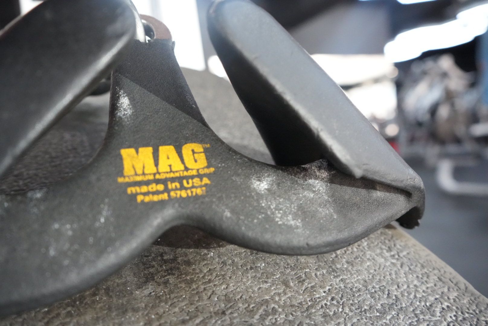Black MAG fishing lure on carpet, with yellow logo text visible