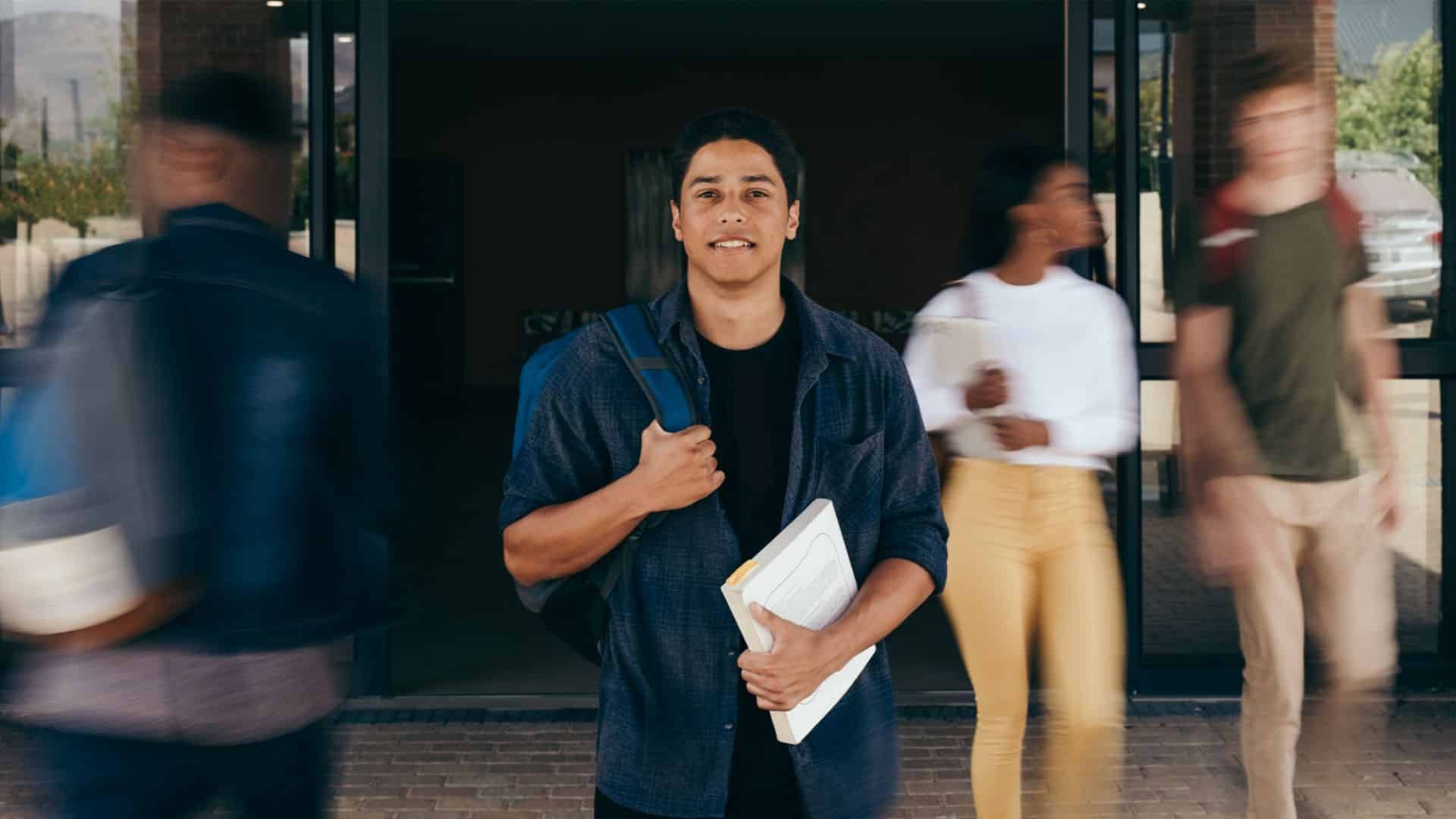 A group of students are walking out of a building.