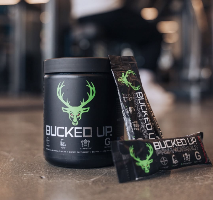 Bucked Up black supplement jar, tube, and packet with neon green deer logo on a countertop.