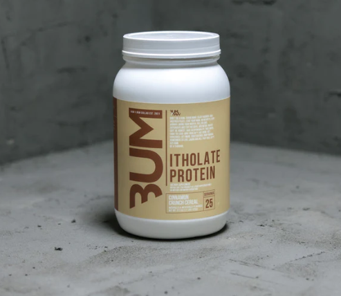 White protein powder jar with beige label reading “3UM Isolate Protein” on a gray surface