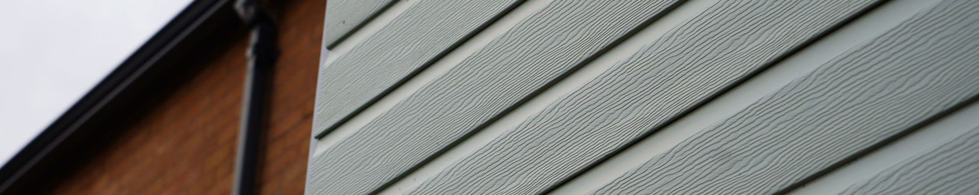 A close up of a siding on the side of a building.