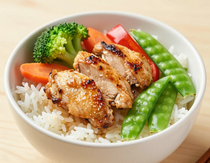 Colorful rice bowl with grilled chicken and vegetables