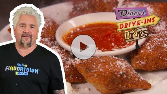 Man beside funnel cake with strawberries and sauce, overlaid with Flavortown Drive-Ins sign and play icon