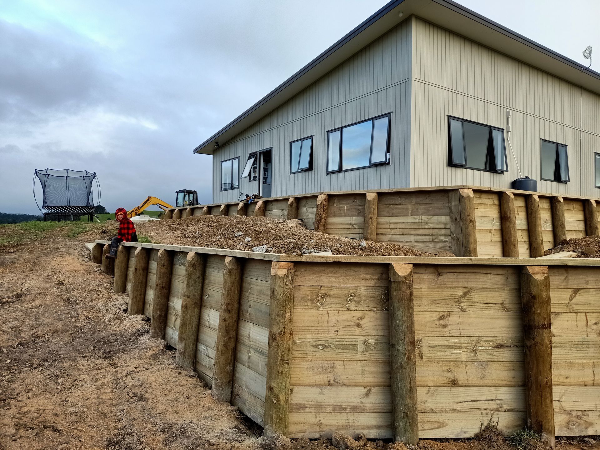 A building with a lot of windows is being built in a field