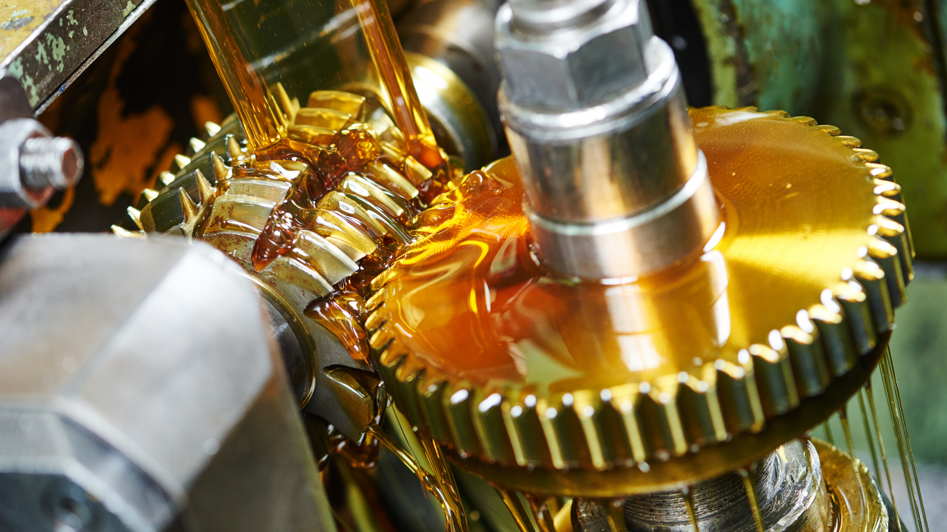 A close-up of a metal part being machined on a lathe, with bright orange sparks flying during the cutting process.