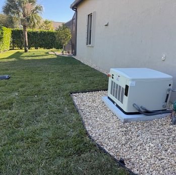 Outdoor HVAC unit on gravel beside a house, next to a grassy backyard.