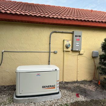 Generac backup generator beside a house wall with electrical meters and conduits, under a red tile roof