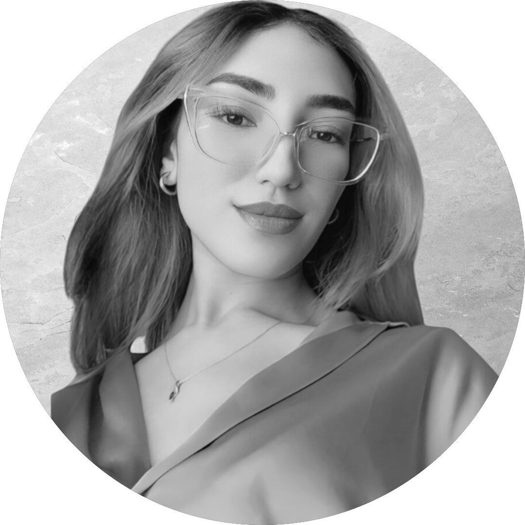 A black and white photo of a woman wearing glasses and a necklace.
