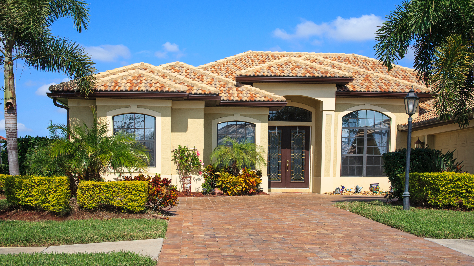 A large house with a brick driveway leading to it