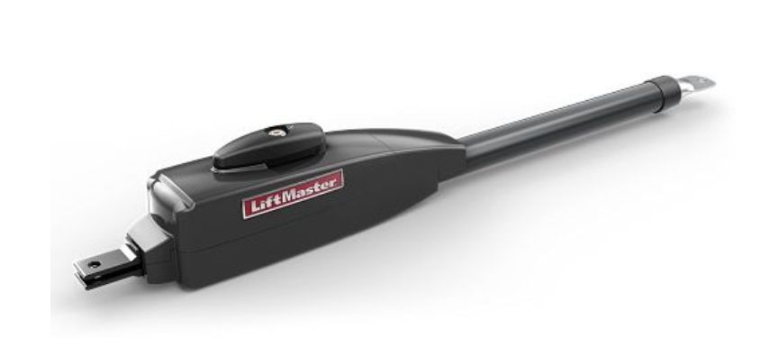 A black garage door opener is sitting on a white surface.