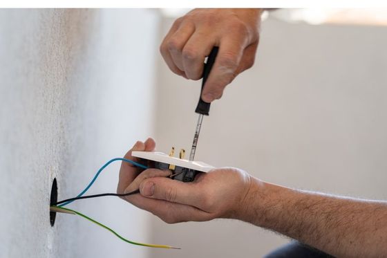 man fixing electric board