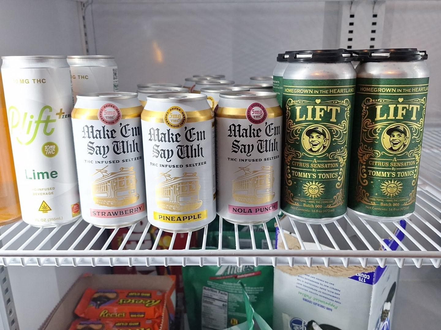 Store shelf with white and gold beverage cans, including Lift sparkling drinks and Malt & Sapph cans.