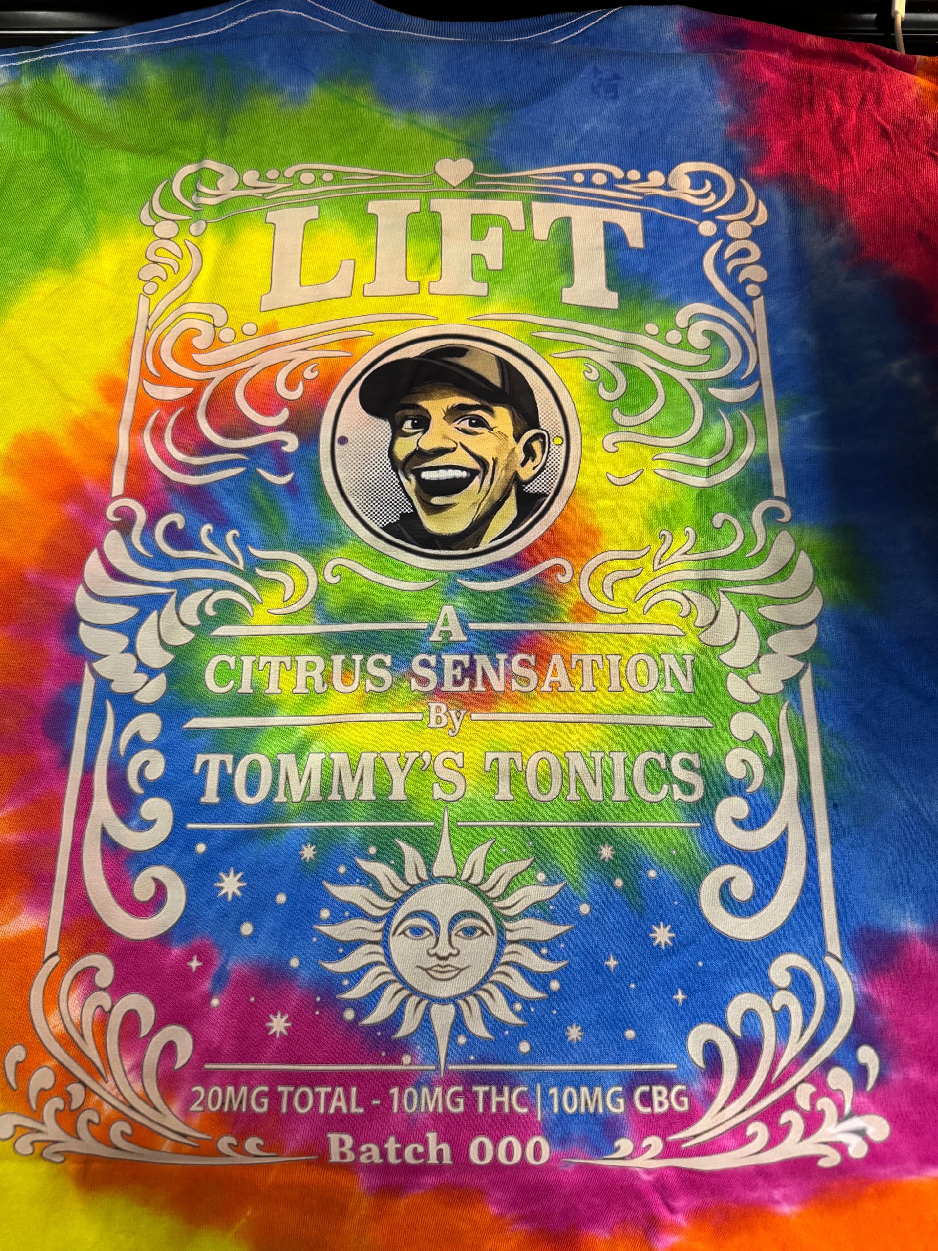 Colorful Tommy Tones Lift citrus-sensation album cover with illustrated smiling face and ornate swirls