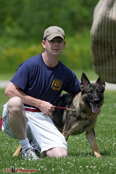 Lil Monster Photography photographer posing with his GSD during a training session. 