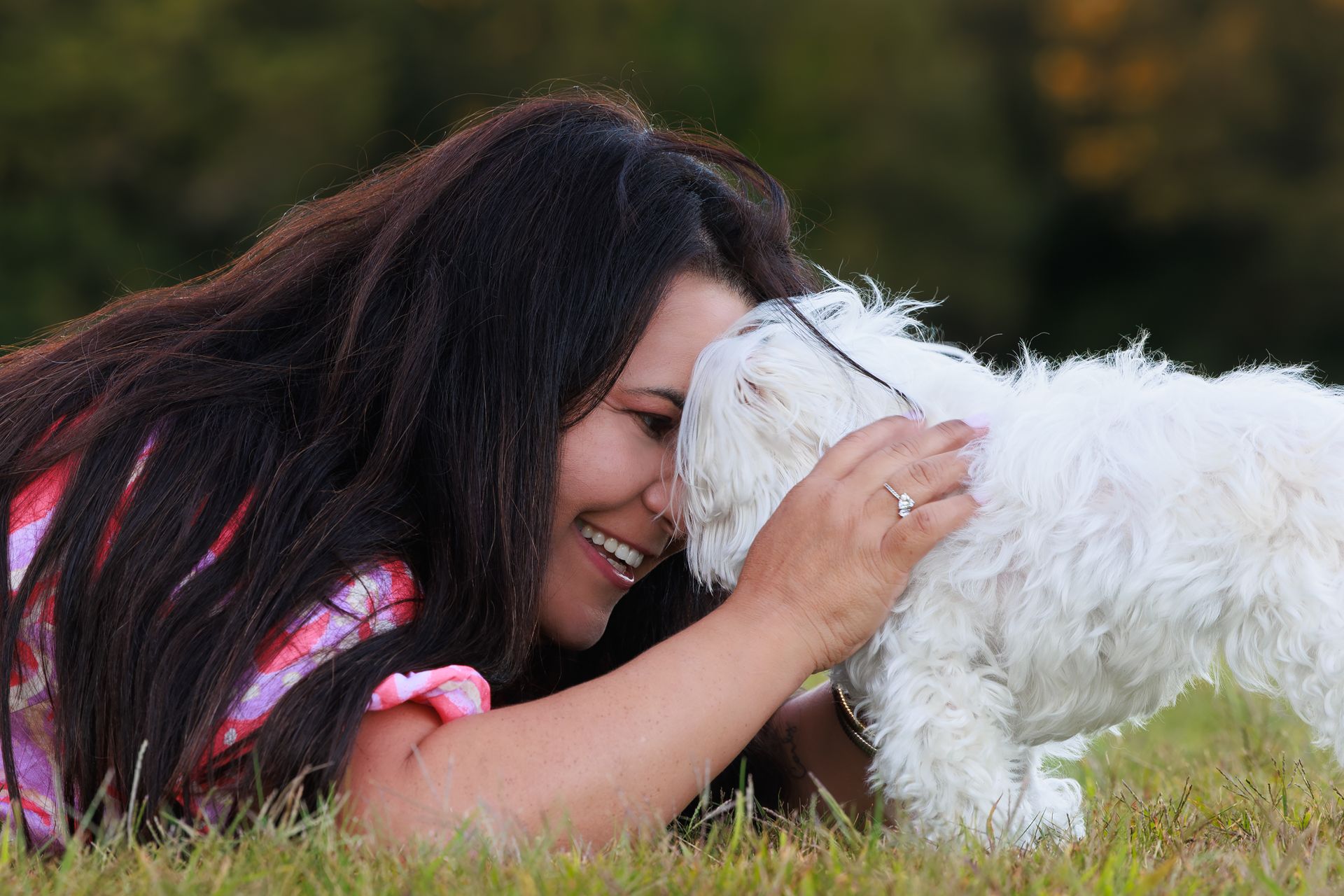 A dog owner poses with the dog during a photo session in Massachusetts
