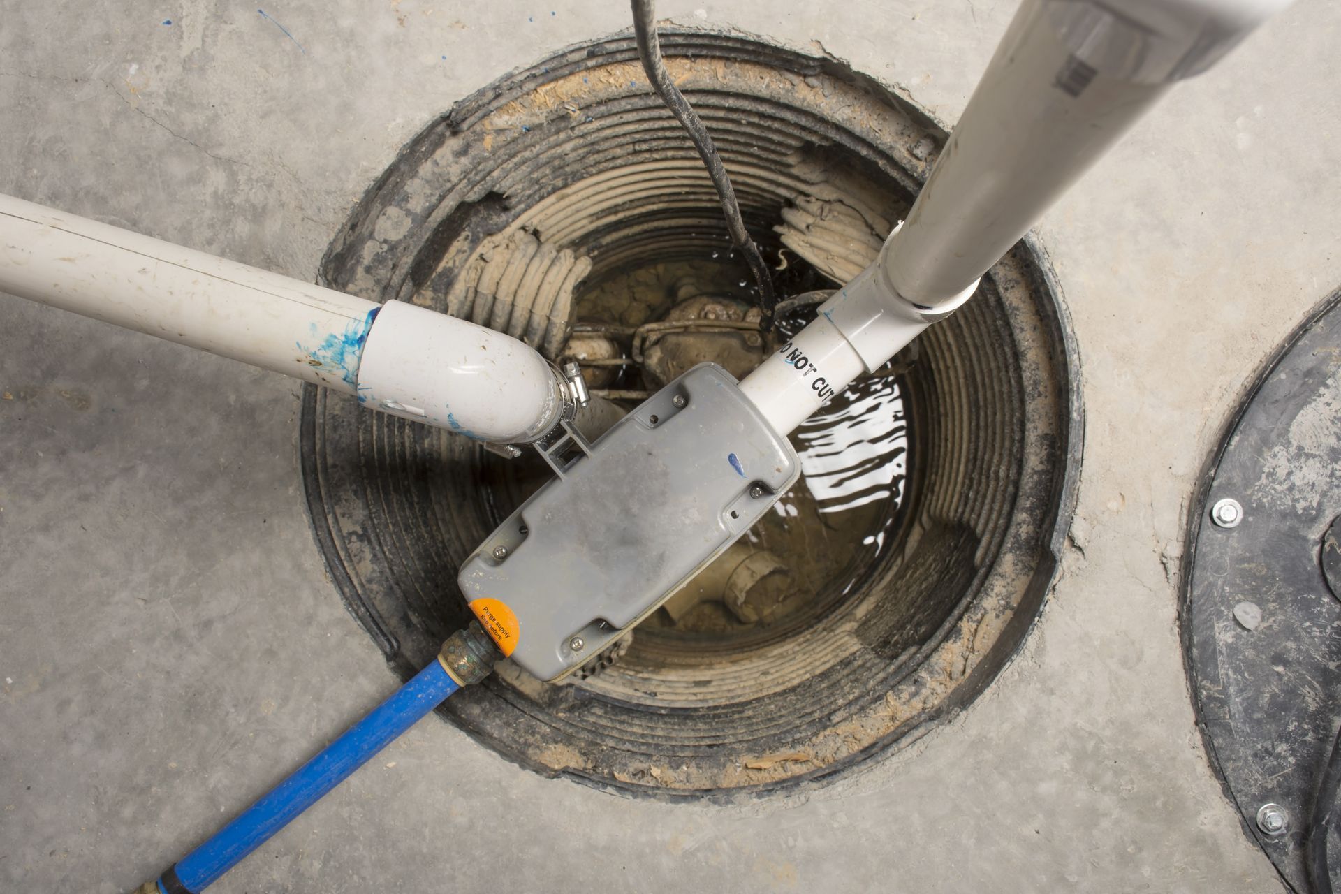 A close-up of a metal pipe and valve fitting completely coated in thick, white frost or ice.