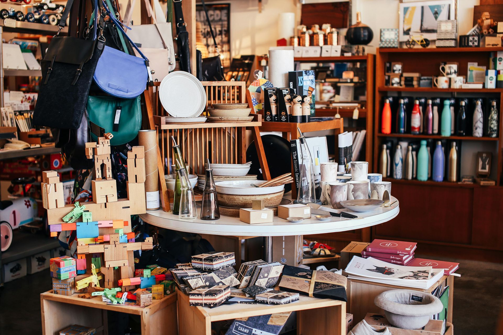 A store filled with lots of items including a table and shelves.