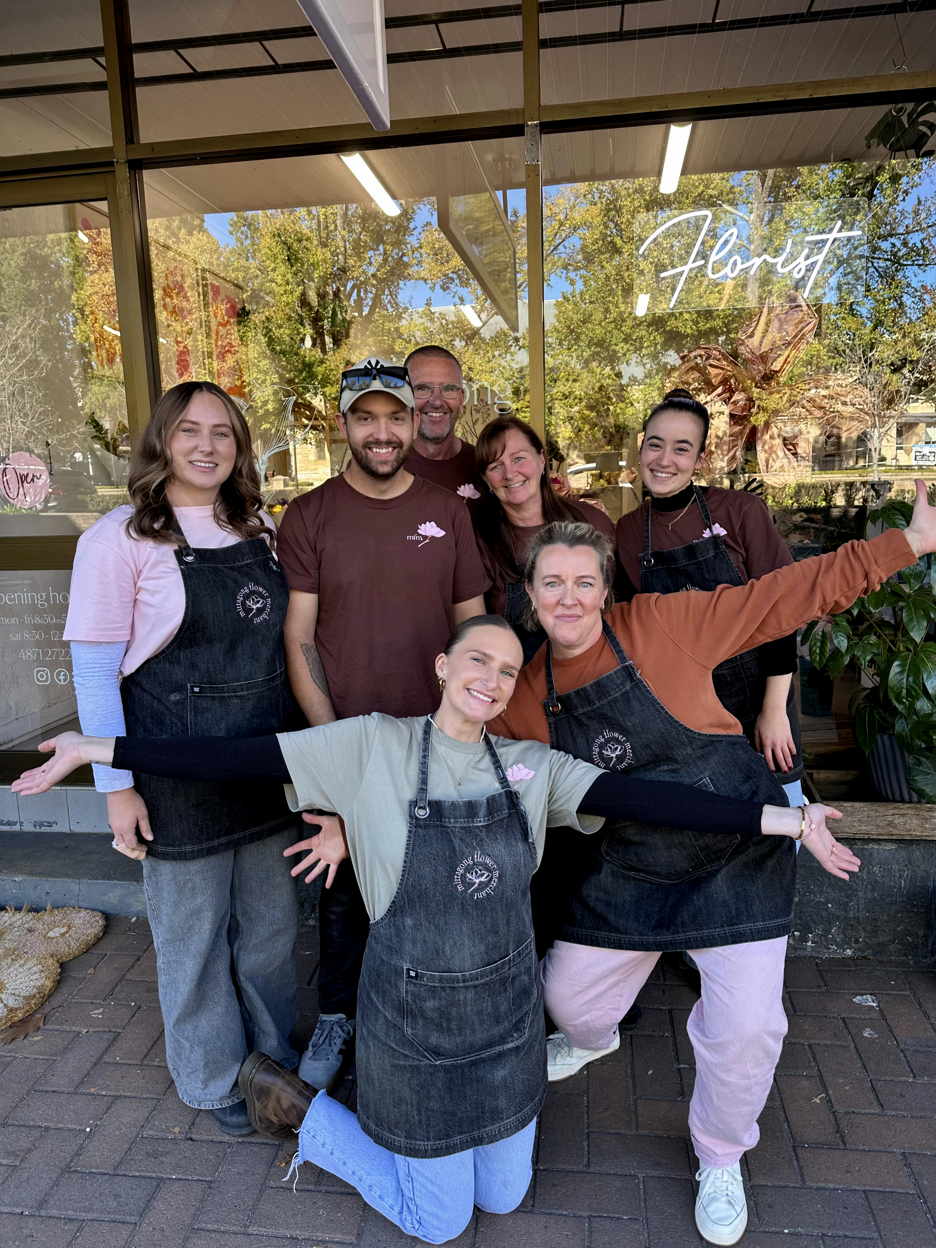 A Group Of Women Are Posing For A Picture Together In A Room — Mittagong Flower Merchant in Mittagong, NSW
