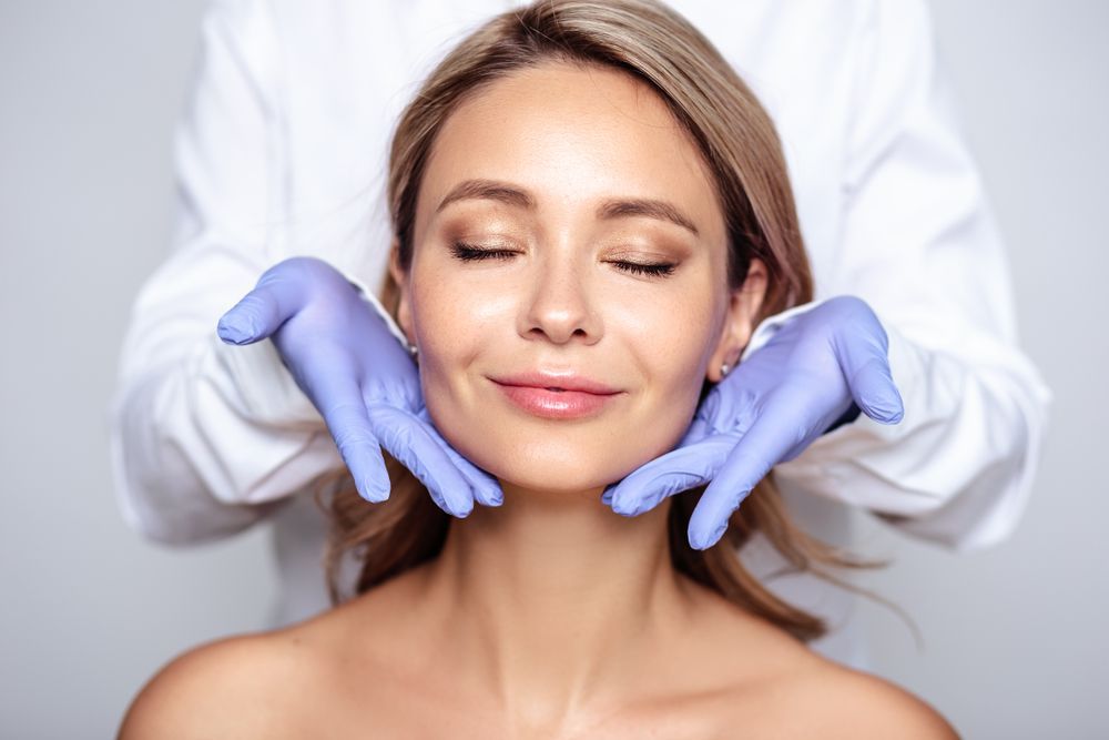 A Woman is Getting Her Face Examined by a Doctor — Kàllos Aesthetics by Nurse Kellie In Hervey Bay, QLD