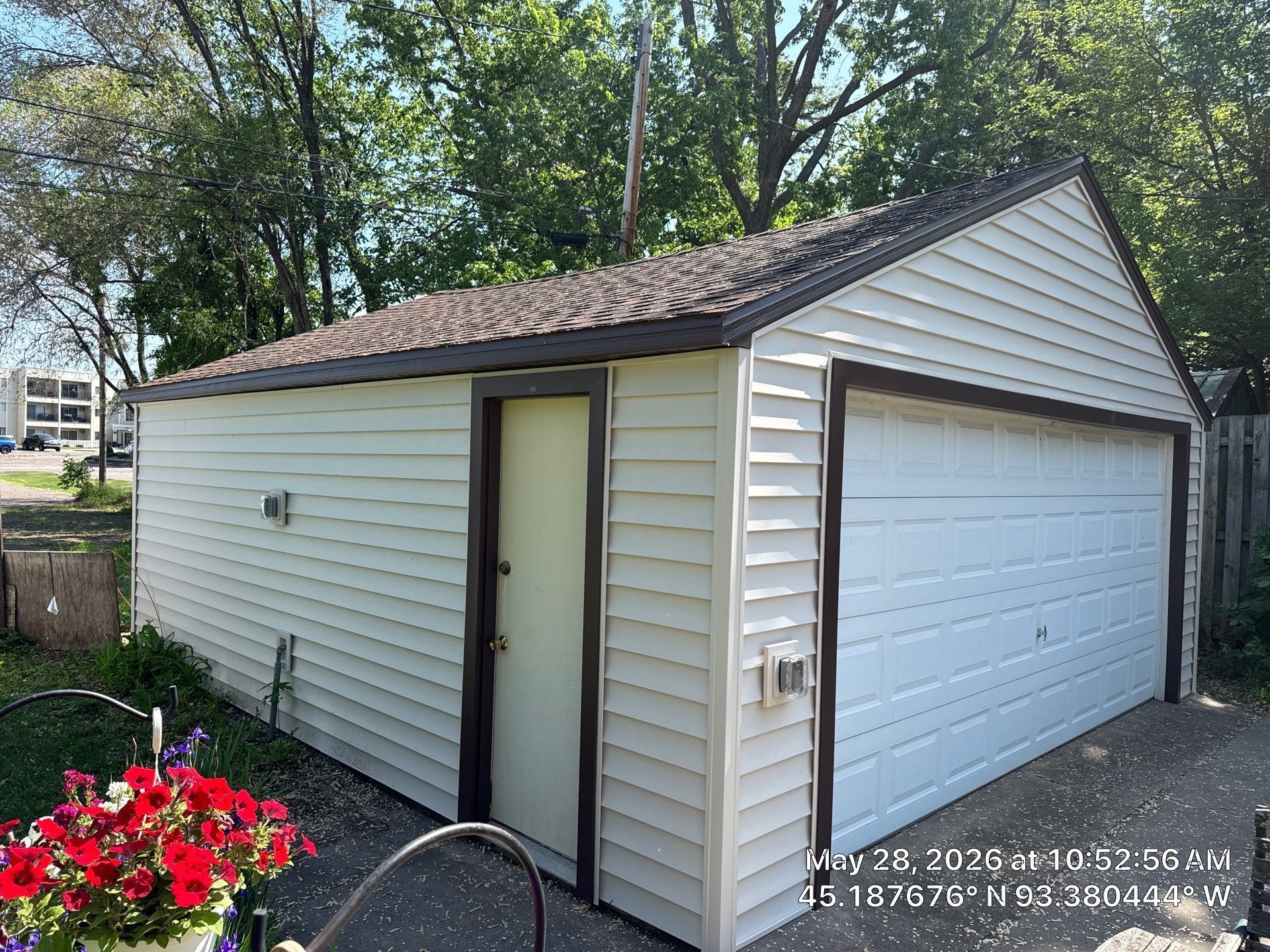 A detached garage with a new roof and siding installed by ABC Seamless of Maple Grove.