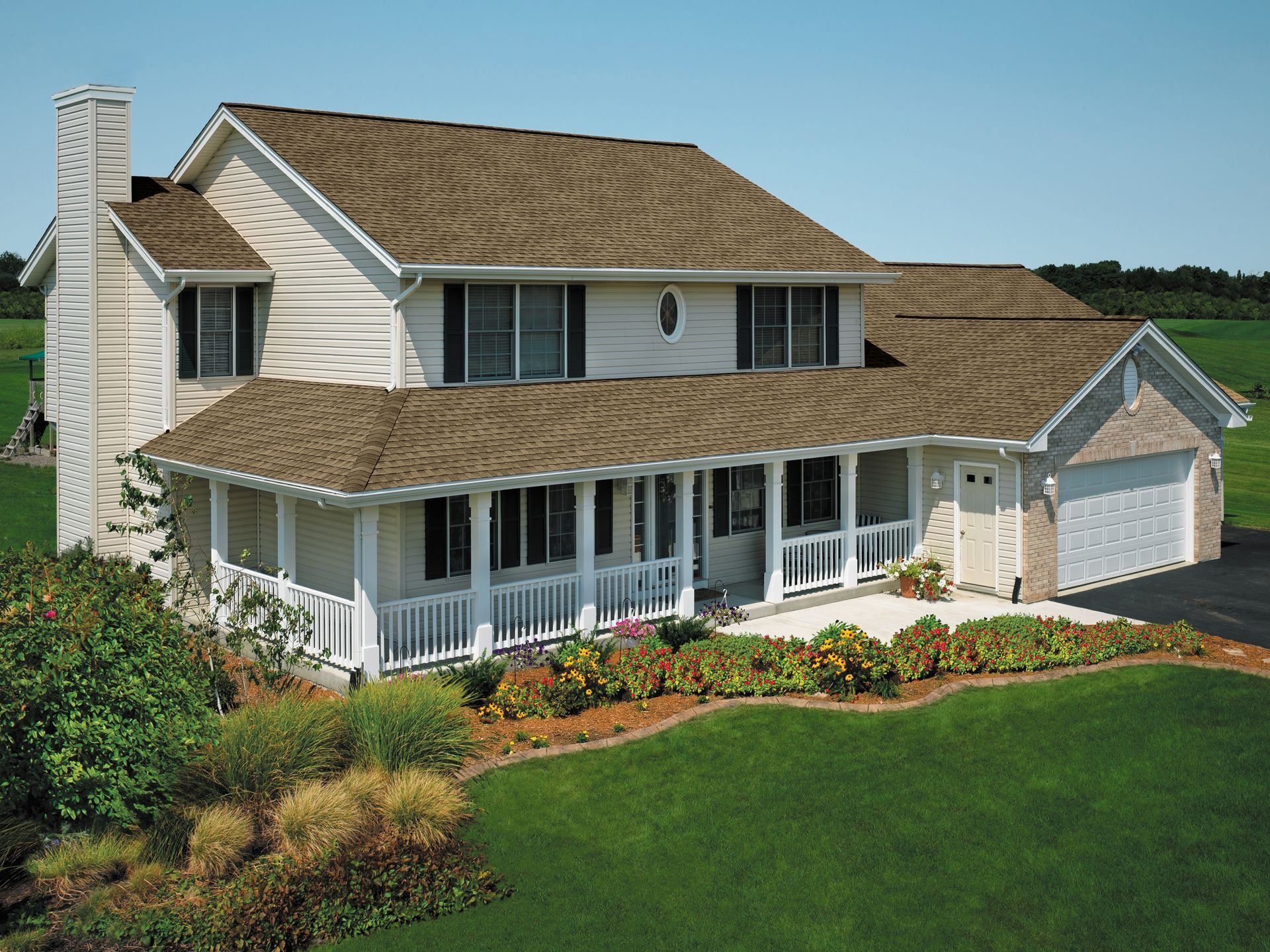A large house with a brown roof and a large porch