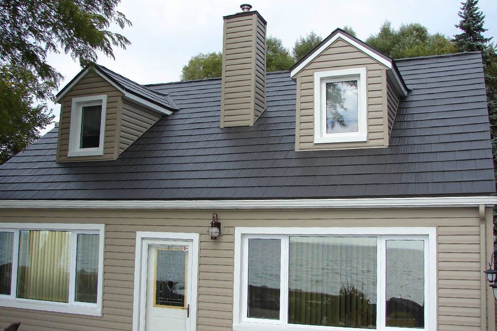 A house with a black roof and white windows