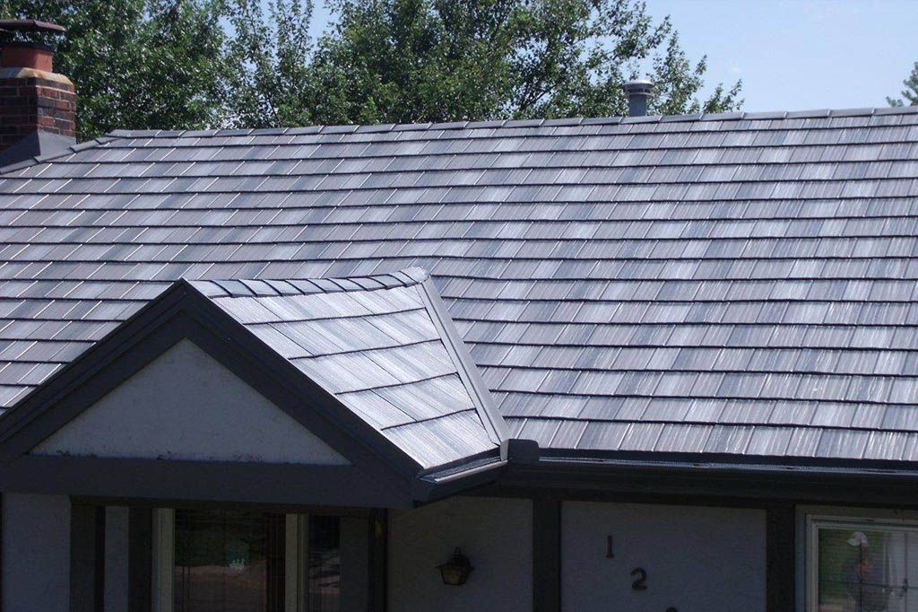 A house with a slate roof and a chimney