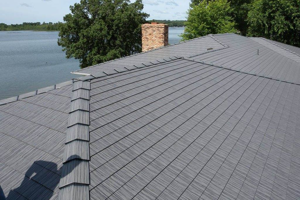 A roof with a chimney and a lake in the background