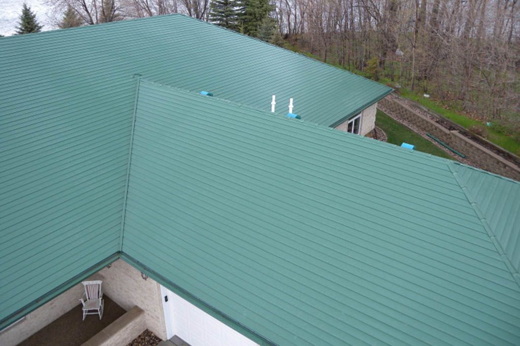 An aerial view of a house with a green roof.