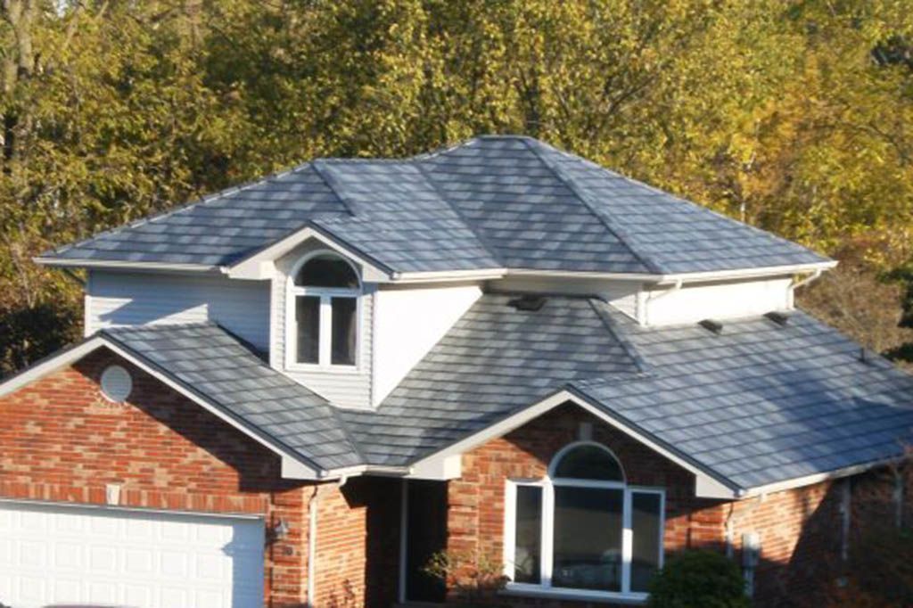 A brick house with a gray roof and white trim