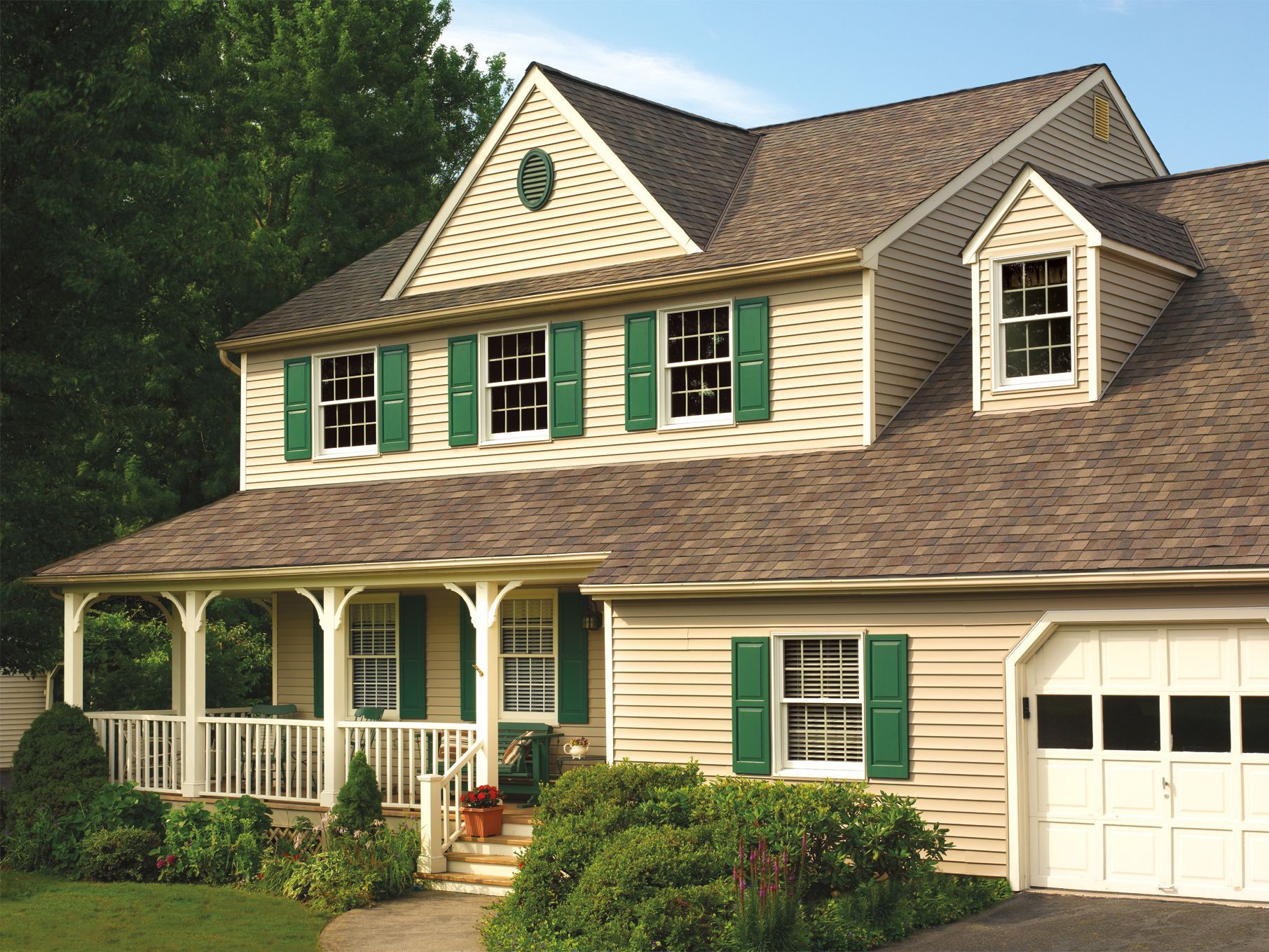 A house with green shutters and a white garage door