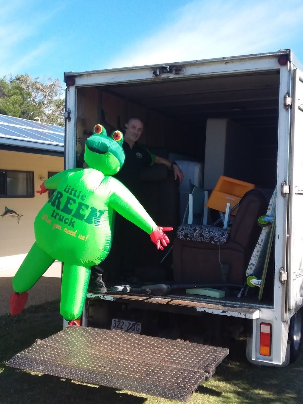 Inflatable Character in a Box Truck, Reaching Out From the Open Cargo Area — Little Green Truck Bundaberg In Gladstone, QLD