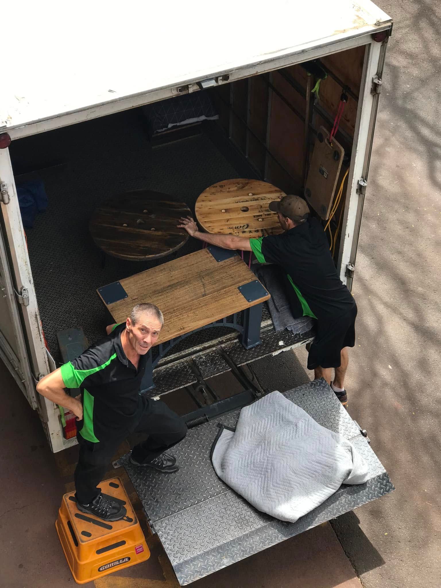 Worker Unloading Furniture from A Truck with A Hand Truck and Blankets — Little Green Truck Bundaberg in Burrum Heads, QLD