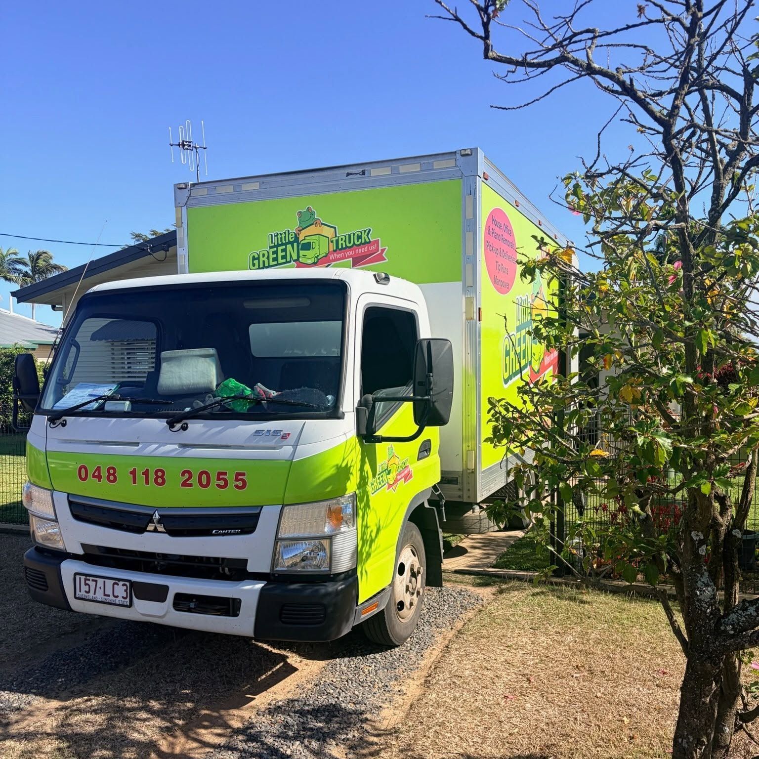 White and Green Removal Truck Parked on A Gravel Driveway Beside a Leafy Yard — Little Green Truck Bundaberg in Burnett Heads, QLD