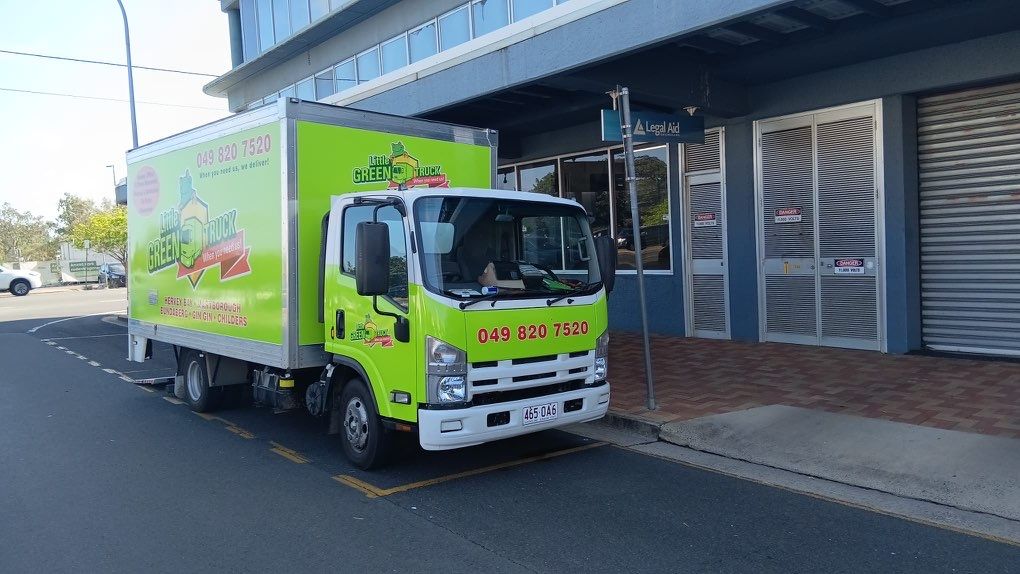 Bright Green Delivery Truck Parked Beside a Building on a Street — Little Green Truck Bundaberg In Rockhampton, QLD