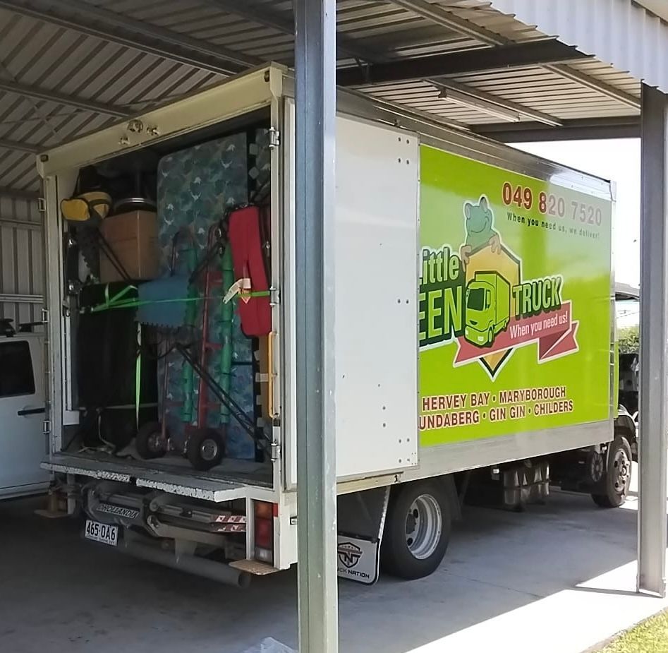 Moving Truck Loaded With Items Parked Under a Carport — Little Green Truck Bundaberg In Maryborough, QLD
