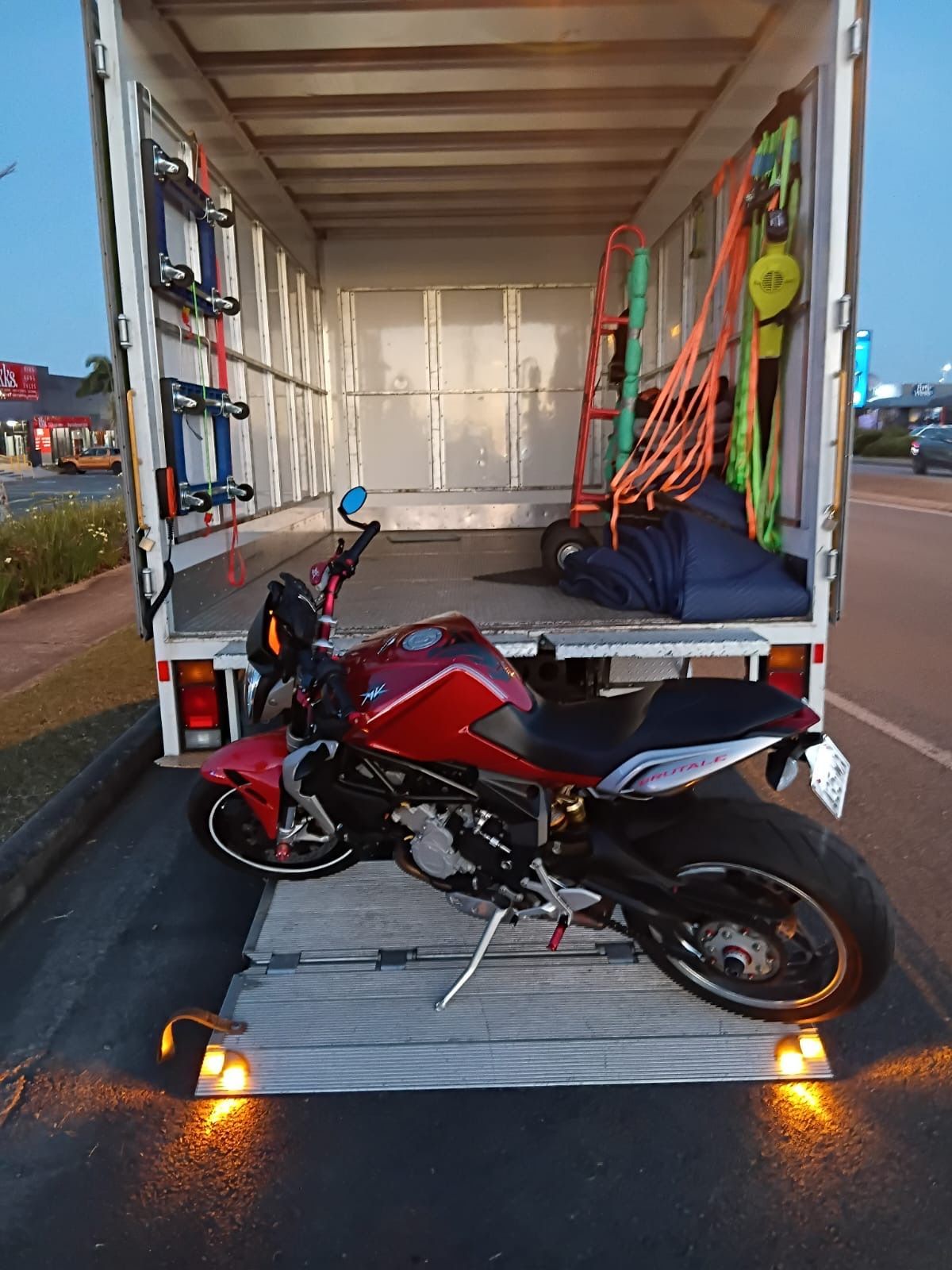 Red Motorcycle Inside a White Truck, Likely Being Transported — Little Green Truck Bundaberg In Bundaberg, QLD