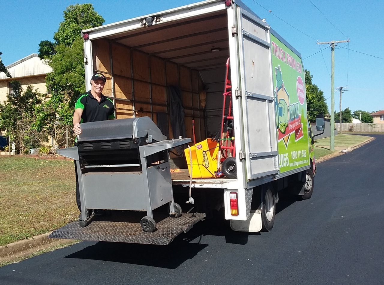 Man Unloading a Grey Grill From a White Moving Truck — Little Green Truck Bundaberg In Gin Gin, QLD