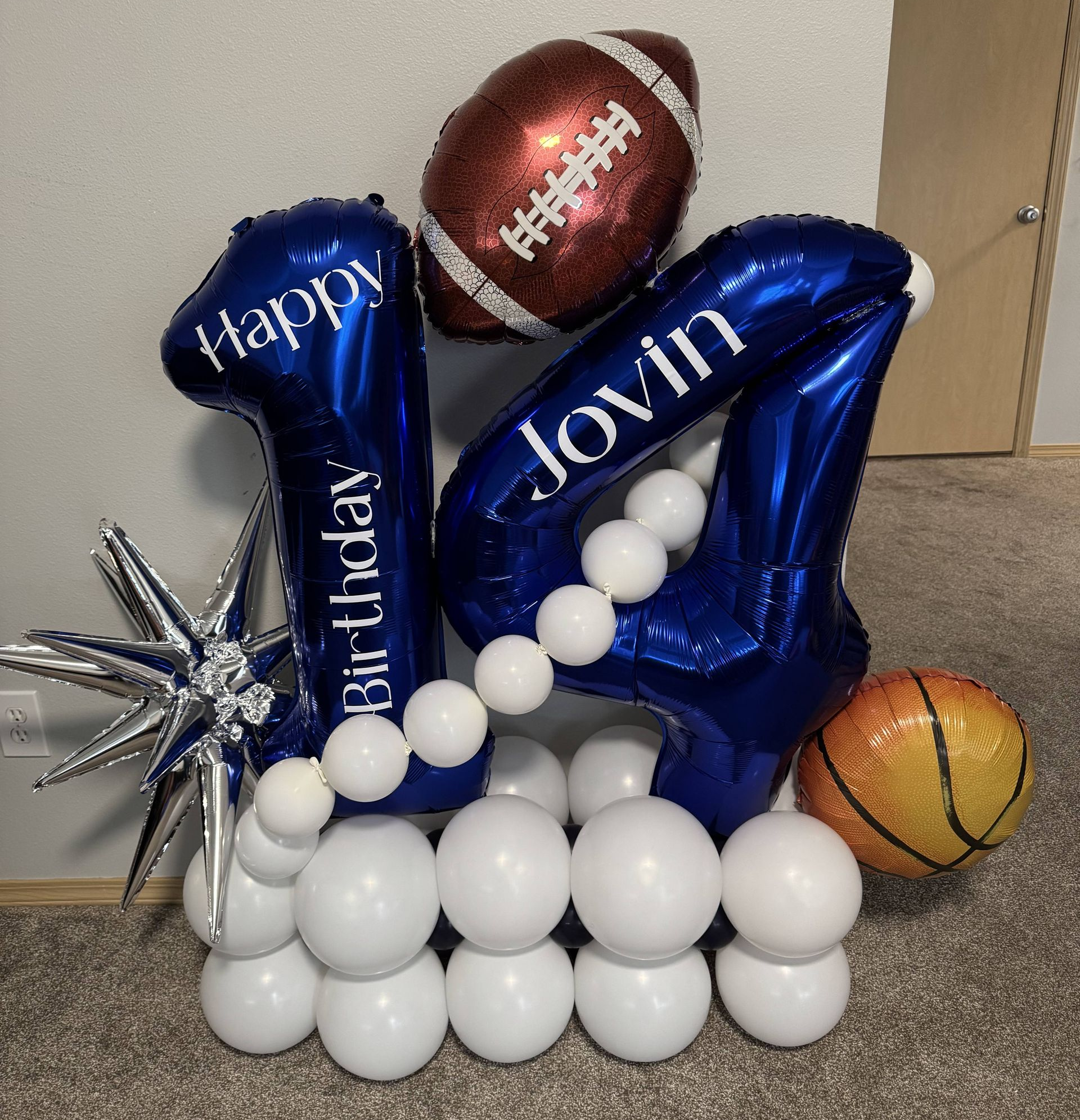 sports themed birthday party with blue and orange balloons