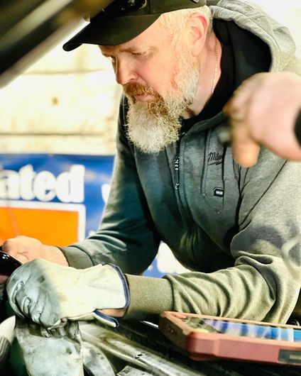 Mechanic working on a car engine | Yunker Motorwerx