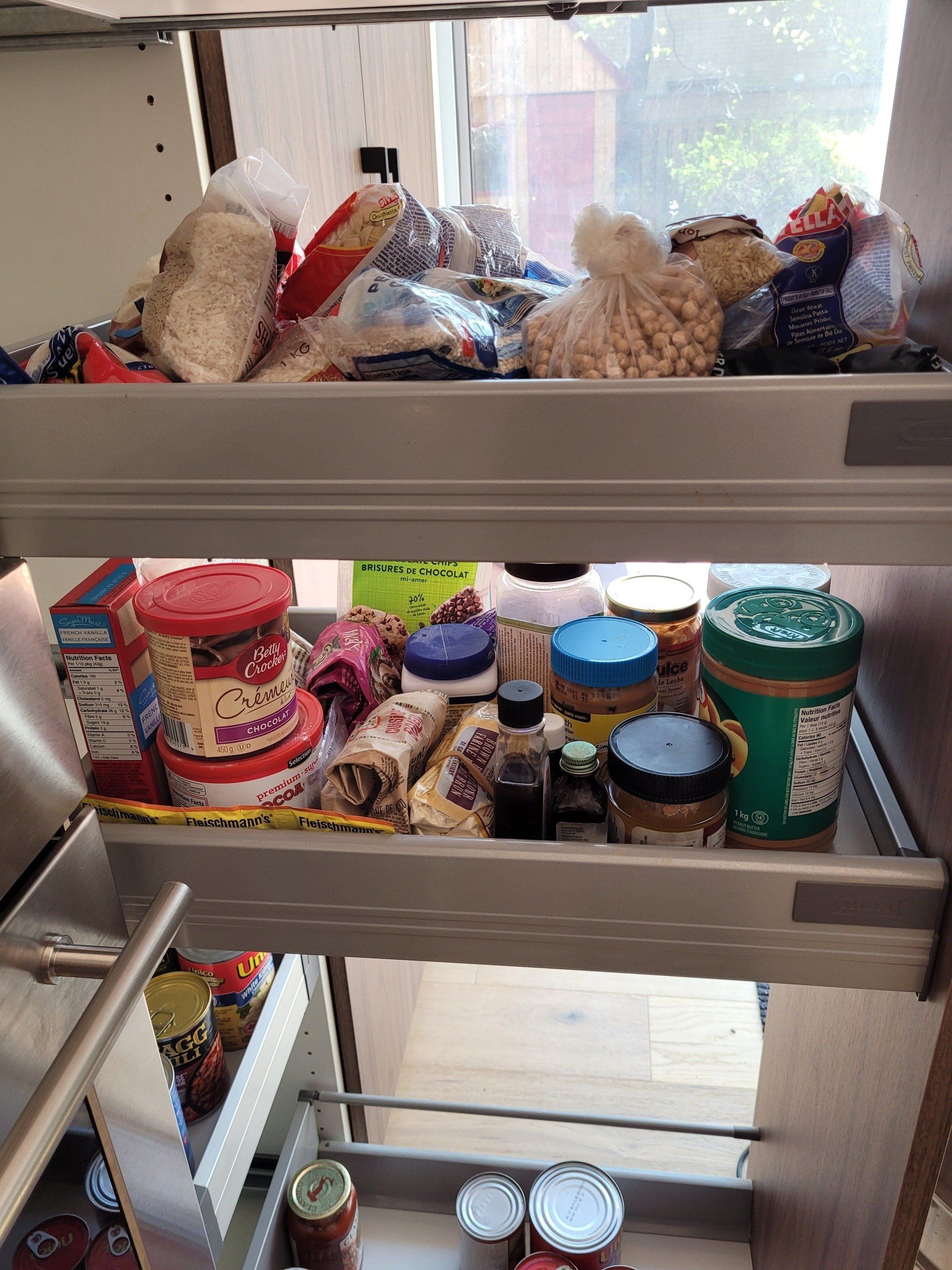 A kitchen pantry filled with lots of food and supplies.
